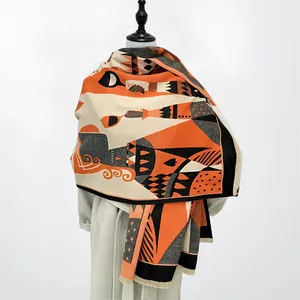Close-up of thick scarf with poker symbols, orange and black blocks and fringe trim