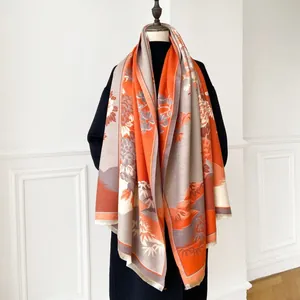 Detail of winter cashmere shawl with traditional floral patterns and fringe edges