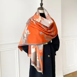 Detail of winter cashmere-like scarf with vintage floral patterns and fringe edges