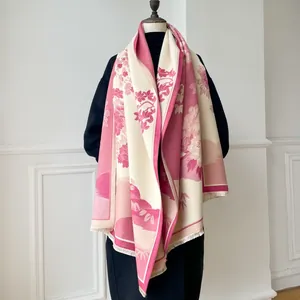 Close-up of pink floral landscape pattern on thick cashmere-like shawl with fringe