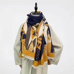 Detail of navy blue and mustard yellow poker pattern scarf with fringe edges