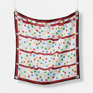 Detailed close-up of square scarf with colorful dots, metal locks and buckle motifs