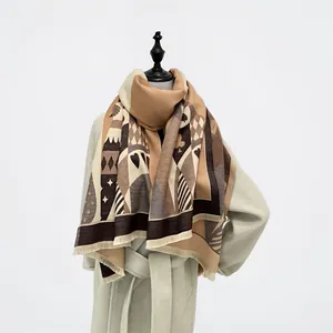 Close-up of winter scarf with poker suit patterns, soft tassels, and camel color tones