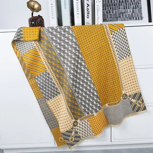 Detail of winter thick scarf with houndstooth pattern, color blocking and tassels
