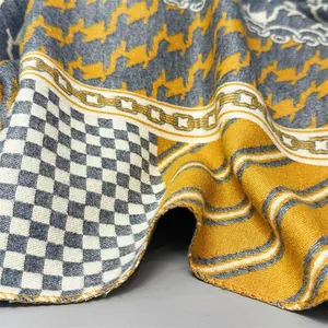 Detail of soft houndstooth and chain pattern scarf with premium lockstitch edges