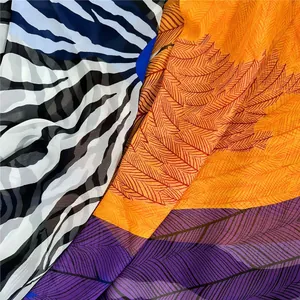 Detail of sheer georgette scarves with zebra and feather prints in various colors