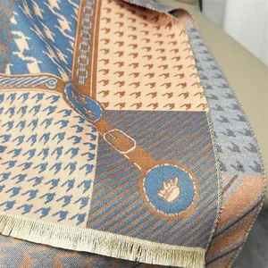 Detail of houndstooth patterns and chain motifs with tassels on a thick pashmina scarf