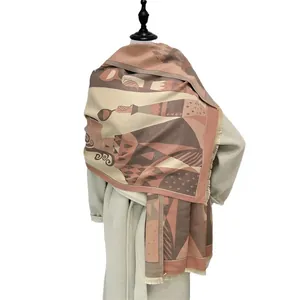 Abstract geometric scarf with fringe, pink-brown knit shawl shown on model in white coat