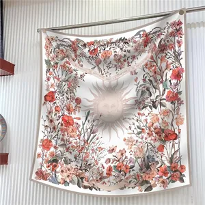 Elegant sun god silk scarf with spring floral borders shown hanging on a metal rod