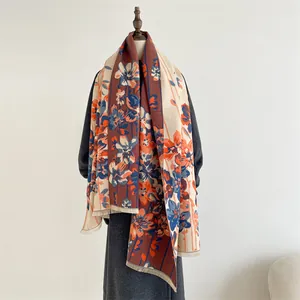 Detail of floral cashmere-feel shawl with vintage patterns and delicate fringe trim