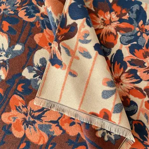 Close-up of double-sided jacquard shawl with floral patterns and soft tassel edges