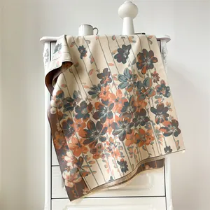 Detail of vintage floral cashmere scarf with soft fringes and oil painting print texture