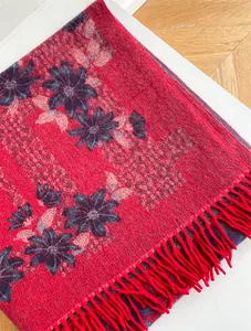 Detail of red floral scarf with soft imitation cashmere texture and fringe tassels