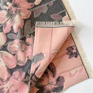 Detailed view of floral cashmere shawl showing double-sided jacquard weave and tassels