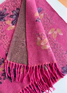 Close-up of floral jacquard cashmere shawl with fringe detail in magenta pink and gold