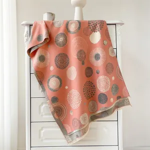 Detail of coral pink bohemian scarf featuring mandala geometric prints and fringe edges