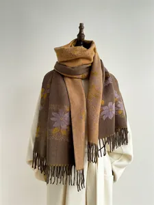 Macro detail of autumn floral scarf showing thick cashmere-like texture and neat fringes
