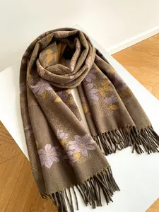 Detail of floral cashmere-like shawl scarf with thick fringe and retro flower pattern