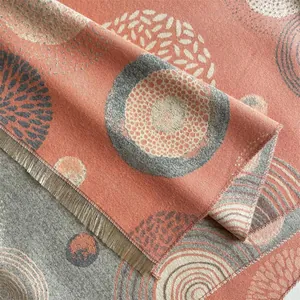 Detail of bohemian scarf showing geometric patterns and woven tassel textures