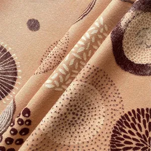 Detail of bohemian cashmere-like scarf showing warm orange tones and intricate patterns