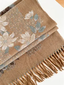 Detailed close-up of khaki floral cashmere scarf with delicate fringe and soft texture