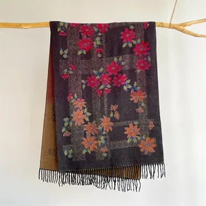 Detailed view of dark purple cashmere scarf featuring red floral patterns and black fringes