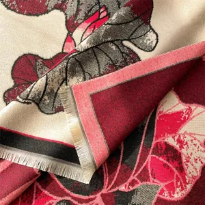 Macro detail of winter lotus floral scarf showing jacquard texture and fringe edges