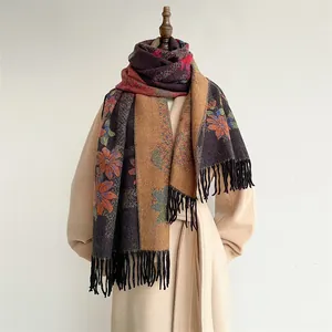 Detailed view of floral jacquard embroidery on vintage cashmere-feel scarf with black tassels