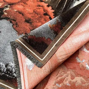 Detailed close-up of thick jacquard woven fabric with warm earth tones and long fringes