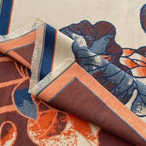 Detail view of ethnic lotus jacquard shawl featuring navy blue and orange fringed edges