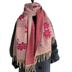 Pink floral cashmere-like scarf with tassels styled on a dark coat for autumn and winter