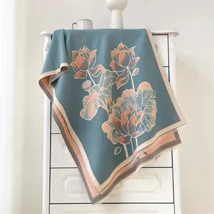 Detail of blue lotus shawl with ethnic floral jacquard and fringed hem edge