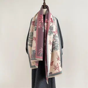 Detail of French toile de jouy scarf with tropical patterns and fringed edges on a model