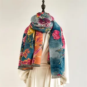 Detailed view of floral oil painting style thick scarf with fringe on white coat