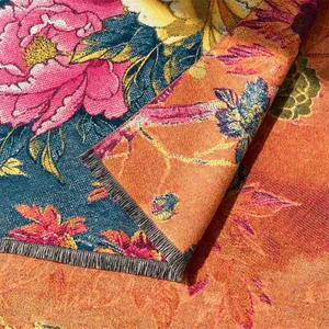 Close-up of thick winter scarf with oil painting floral patterns and black fringe