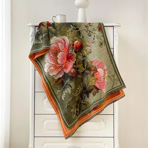 Detail of oil painting style scarf with pink peony floral patterns and grey fringe tassels