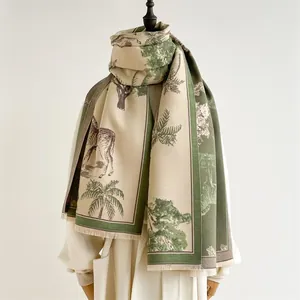 Detail shot of zebra and palm tree prints on soft fringe cashmere pashmina scarf