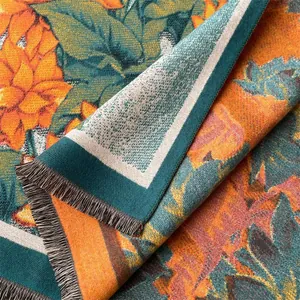 Close-up of winter floral scarf with thick jacquard texture and colorful tassel fringe