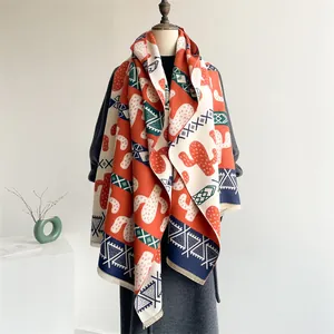Detailed close-up of cactus pattern and ethnic geometric print on a fringed scarf shawl