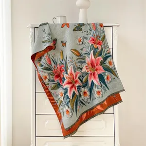 Close-up of floral oil painting style scarf with lily embroidery and tassels