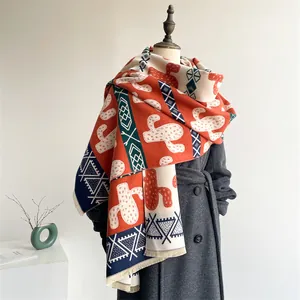 Close-up of geometric pattern and fringe detail on a warm cashmere-feel winter shawl