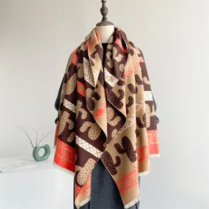 Close-up of bohemian knit shawl with cactus patterns, geometric textures, and long tassels