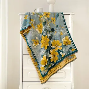 Detail of oil painting style scarf with floral patterns on a vintage blue fabric texture