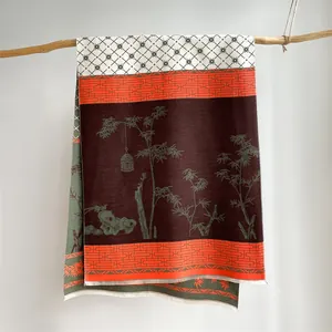 Detail of vintage ethnic scarf on wood branch showing tassels and geometric patterns