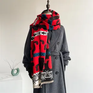 Close-up of thick scarf with red and black geometric patterns and fringe detail