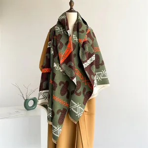 Nordic cashmere-like scarf with green cactus print and bohemian tassels on beige coat
