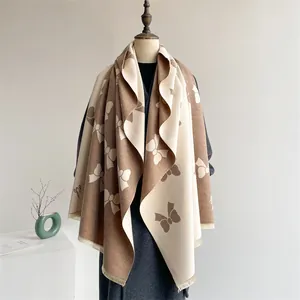 Elegant bow tie jacquard cashmere-feel scarf in caramel and beige with fringe details