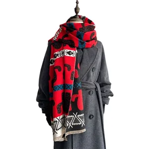 Ethnic geometric cashmere scarf in red and black paired with a long wool coat
