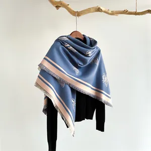 Elegant navy blue cashmere feel scarf with white bee patterns and fringe detail
