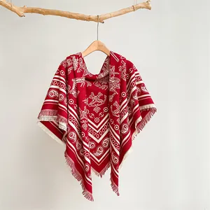 Macro detail of red paisley thick shawl with white nautical prints and soft fringe edge